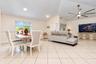 Open-concept interior featuring vaulted ceilings, oversized tile flooring, recessed lighting, and a multi-blade ceiling fan