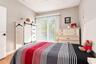 Bedroom featuring vertical sliding glass doors, neutral wall paint, tile flooring, and a ceiling-mounted fan