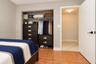 Room featuring tile flooring and a built-in closet with wire shelving
