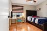 Room featuring wood-finish tile flooring, a dual-tone fabric window shade, and a ceiling-mounted light fixture with a fan