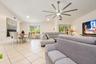 Vaulted ceilings featuring a multi-blade brushed metal ceiling fan and recessed lighting, finished with light-toned ceramic tile flooring and multi-pa
