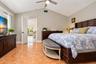 Vaulted ceiling featuring a central brushed-nickel finish ceiling fan and ceramic tile flooring