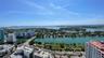 Elevated perspective featuring expansive water frontage, bridges, cityscape skyline, and surrounding coastal landscape