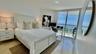 Polished stone flooring, floor-to-ceiling sliding glass doors, and a private balcony