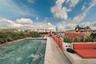 Rooftop terrace featuring a rectangular swimming pool with stone coping, built-in masonry seating, stone flooring, and perimeter planters