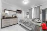 Room featuring large-format tile flooring with a neutral veined pattern, crown molding, and a central flush-mount ceiling light fixture