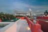 Rooftop terrace featuring stone flooring, a built-in pool, a covered pergola, and masonry perimeter walls