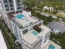 Multi-level terrace architecture featuring tiered swimming pools, integrated spas, glass balustrades, and pergola-covered outdoor areas