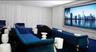 Media room featuring a wall-mounted display, recessed ceiling lighting, wall-to-wall carpeting, and full-height floor-to-ceiling drapery