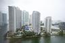 High-rise residential complex featuring waterfront positioning, tennis courts, multiple swimming pools, and landscaped grounds