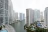 Elevated urban perspective featuring high-rise architecture, waterway frontage, and a podium-level swimming pool