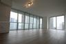 Floor-to-ceiling windows, wood-finish flooring, and multi-directional track lighting