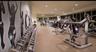 Fitness space featuring floor-to-ceiling windows, full-length wall mirrors, and recessed lighting
