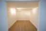 Interior space featuring wood-finish flooring, smooth wall surfaces, and ceiling-mounted track lighting