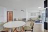 Polished stone flooring, floor-to-ceiling glass sliding door, and wood-finish interior door