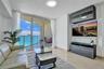 Floor-to-ceiling glass doors, expansive private balcony, polished stone flooring, and built-in high-gloss cabinetry
