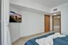 Light-toned tile flooring, solid wood-finish door, and recessed lighting