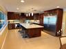 Eat in kitchen with a large island and wine cooler.