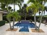 Pool with electric and gas heaters. Waterfall and bench seating throughout the pool.