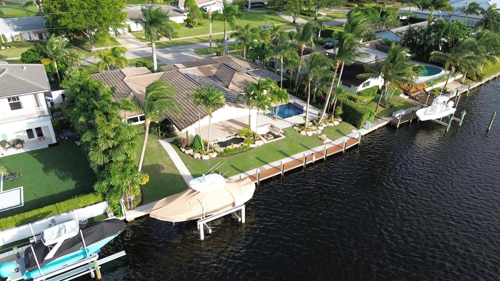 Prestigious waterfront setting along an attractive residential street with sidewalks, showcasing the home's distinguished surroundings.