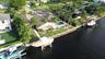 Prestigious waterfront setting along an attractive residential street with sidewalks, showcasing the home's distinguished surroundings.