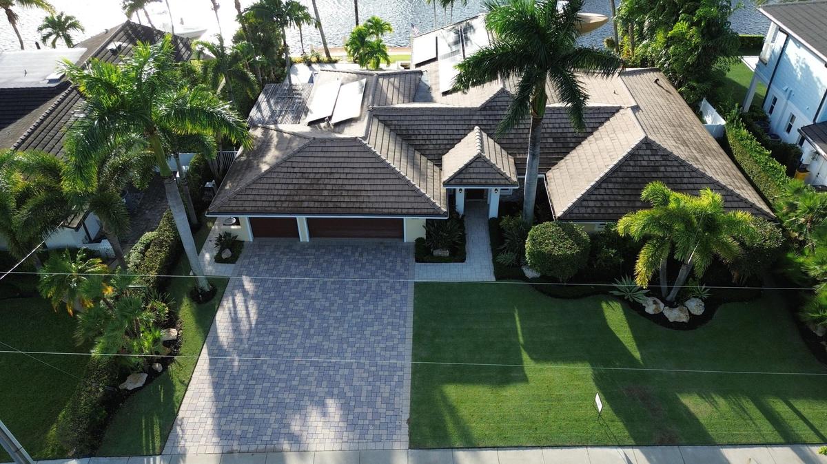 Prestigious waterfront setting along an attractive residential street with sidewalks, showcasing the home's distinguished surroundings. Surrounding