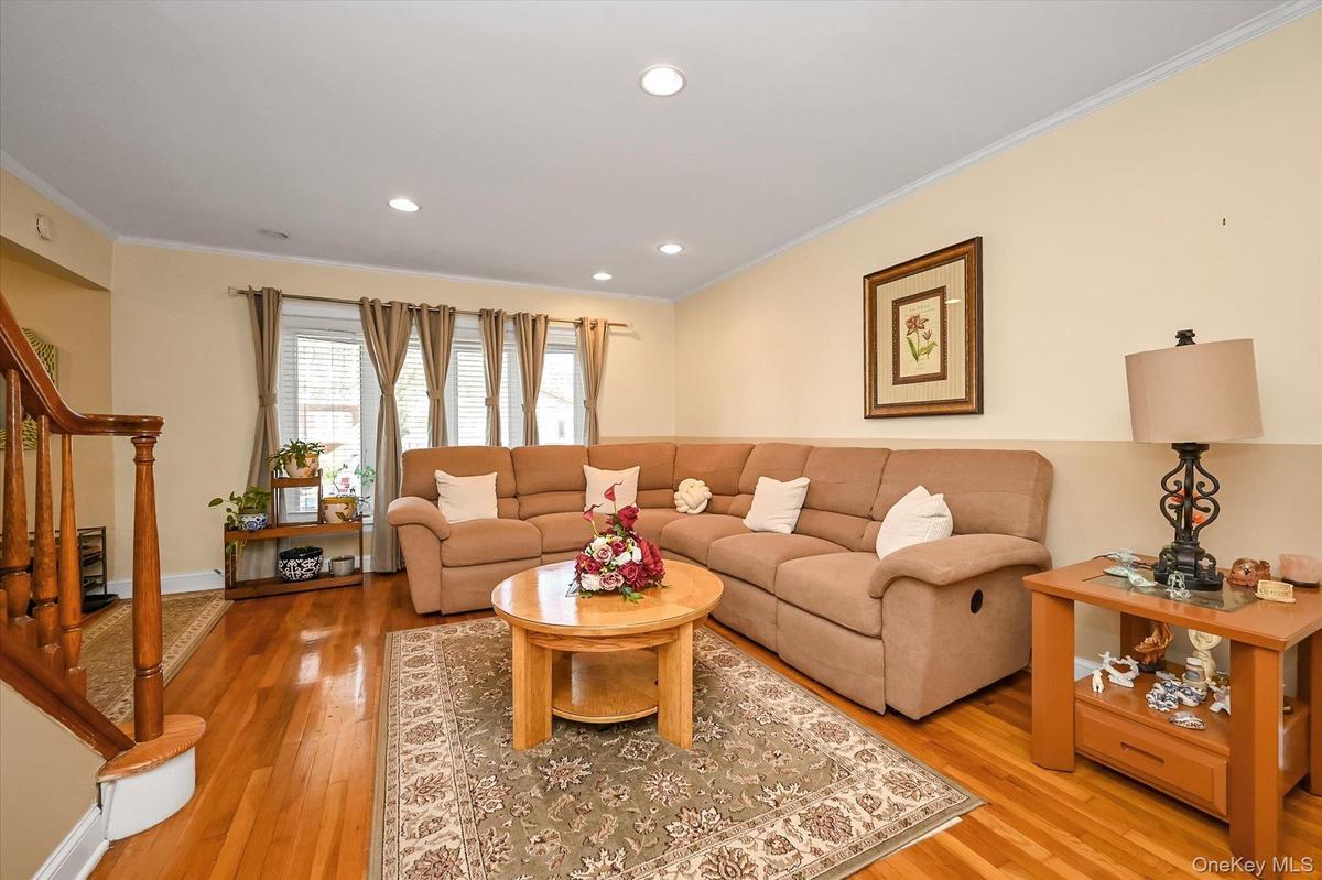Large Living room With beautiful hardwood floors, recess lighting.