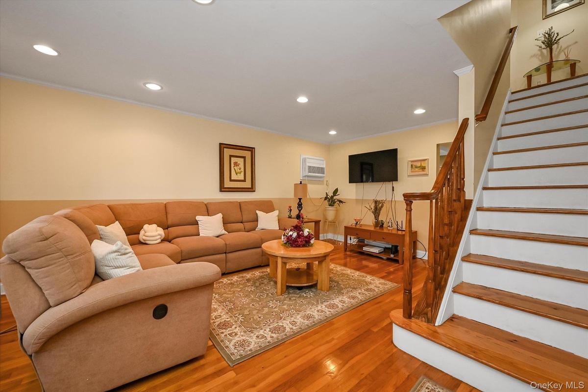 Large Living room With beautiful hardwood floors, recess lighting.