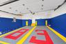 Garage featuring interlocking modular floor tiles, reinforced wall protection, and dual overhead linear lighting