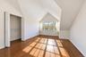 Vaulted ceilings with architectural lines, wood-finish flooring, and a walk-in closet featuring wire shelving