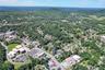Aerial view of property's location with a heavily wooded area