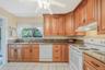 EIK with Beautiful Cabinetry, Granite Countertops, Window Overlooking The Yard, Open to DR and Den