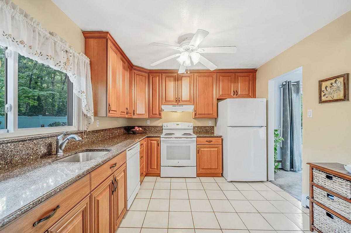 EIK with Beautiful Cabinetry, Granite Countertops, Window Overlooking The Yard, Open to DR and Den