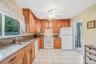EIK with Beautiful Cabinetry, Granite Countertops, Window Overlooking The Yard, Open to DR and Den