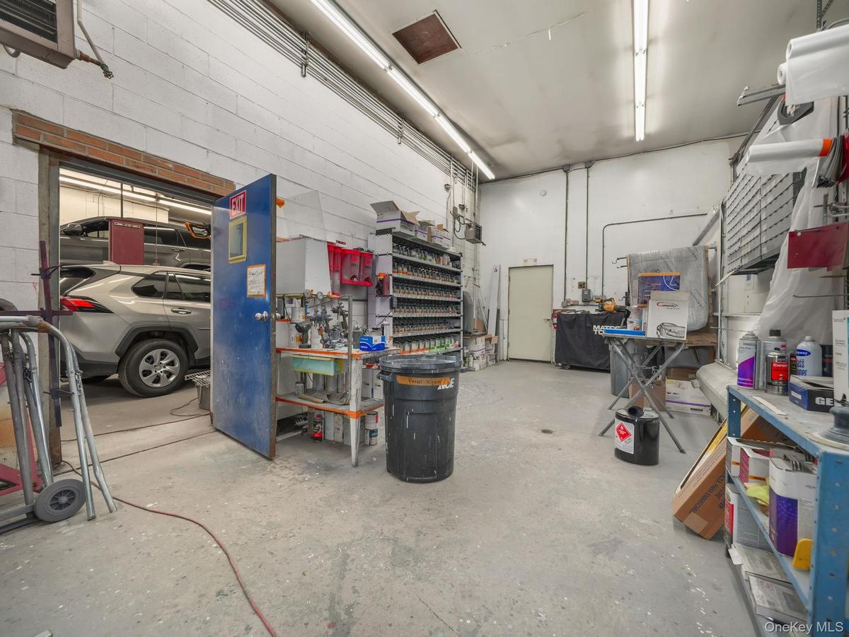 Garage featuring a workshop area and a heating unit