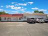 View of commercial property featuring uncovered parking