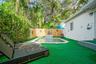 Private outdoor area featuring an in-ground swimming pool with a tile-accented water feature, vertical wood-slat perimeter fencing, and mature surroun