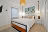 Neutral-toned terrazzo flooring, textured drum pendant lighting, and rope-suspended feature fixtures