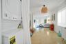 Stacked laundry unit, polished terrazzo flooring, woven pendant lighting, and natural light via multiple windows