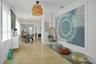 Polished terrazzo flooring, woven drum pendant lighting, and multi-arm geometric ceiling fixture