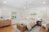 Interior space featuring wood-finish flooring, white plantation shutters, a ceiling fan, recessed lighting, and a wall-mounted wood floating shelf