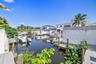 Waterfront property featuring private docks, bulkhead reinforced shoreline, and established tropical landscaping