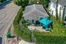 Exterior featuring a hip roof, paved patio, and perimeter hedges providing privacy
