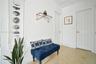 Interior hallway featuring neutral walls, speckled composition flooring, and two six-panel interior doors