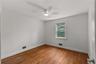 Empty room with wood finished floors and a ceiling fan
