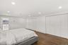 Bedroom with recessed lighting, dark wood-style floors, two closets, and crown molding