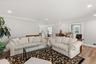 Living area featuring light wood-style flooring, recessed lighting, and crown molding