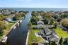 Aerial view of property's location featuring a nearby body of water and nearby suburban area