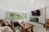Living room with ornamental molding, recessed lighting, and a fireplace