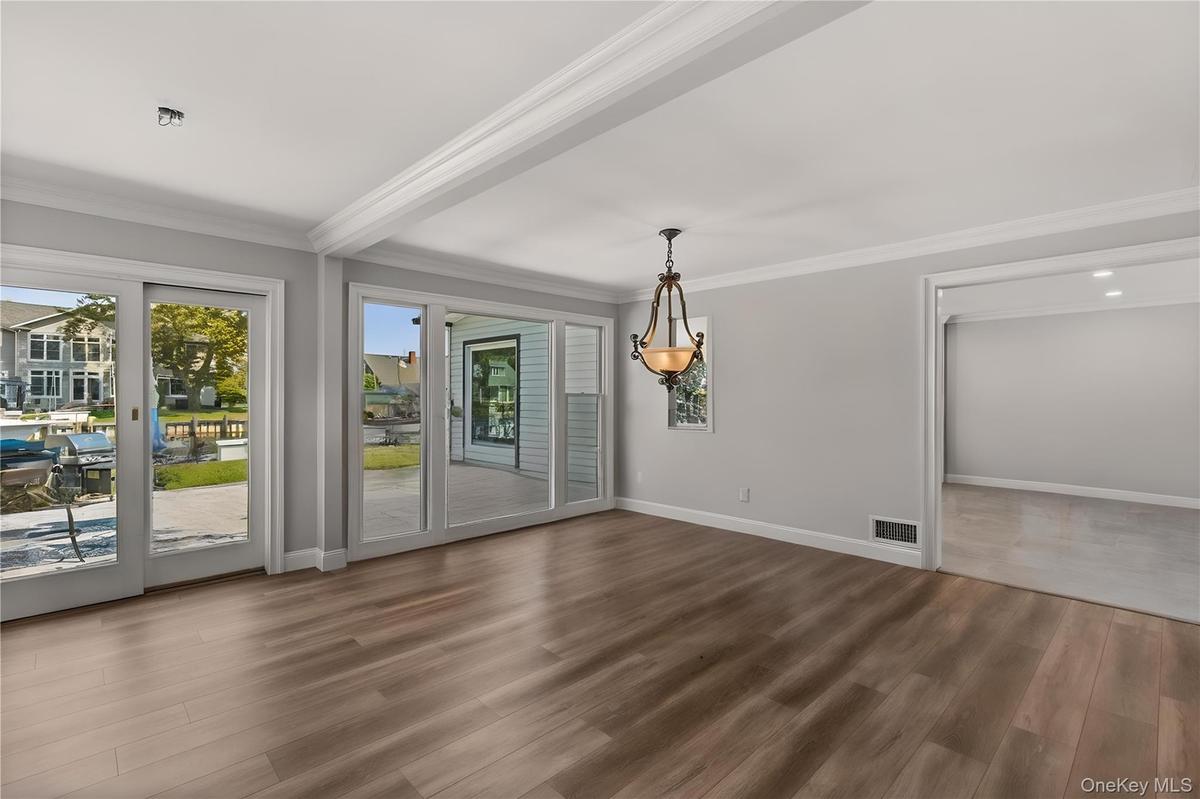 Unfurnished dining area featuring crown molding and wood finished floors